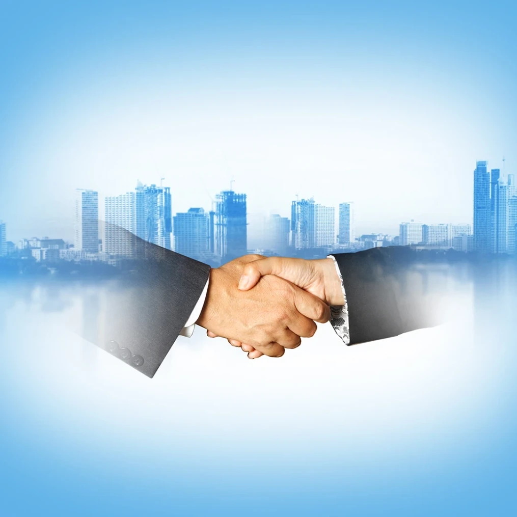 Business handshake with city background